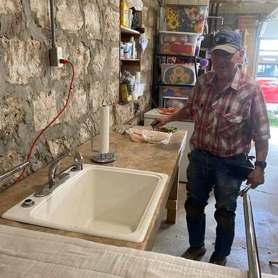 Loren Knapp testing sink with water in processing station